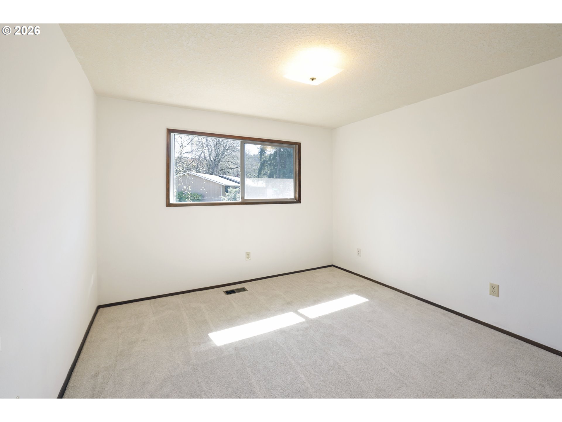 16285 Southwest Rosa Road Beaverton, OR 97007 - Photo 12 of 20 a view of an empty room with a window