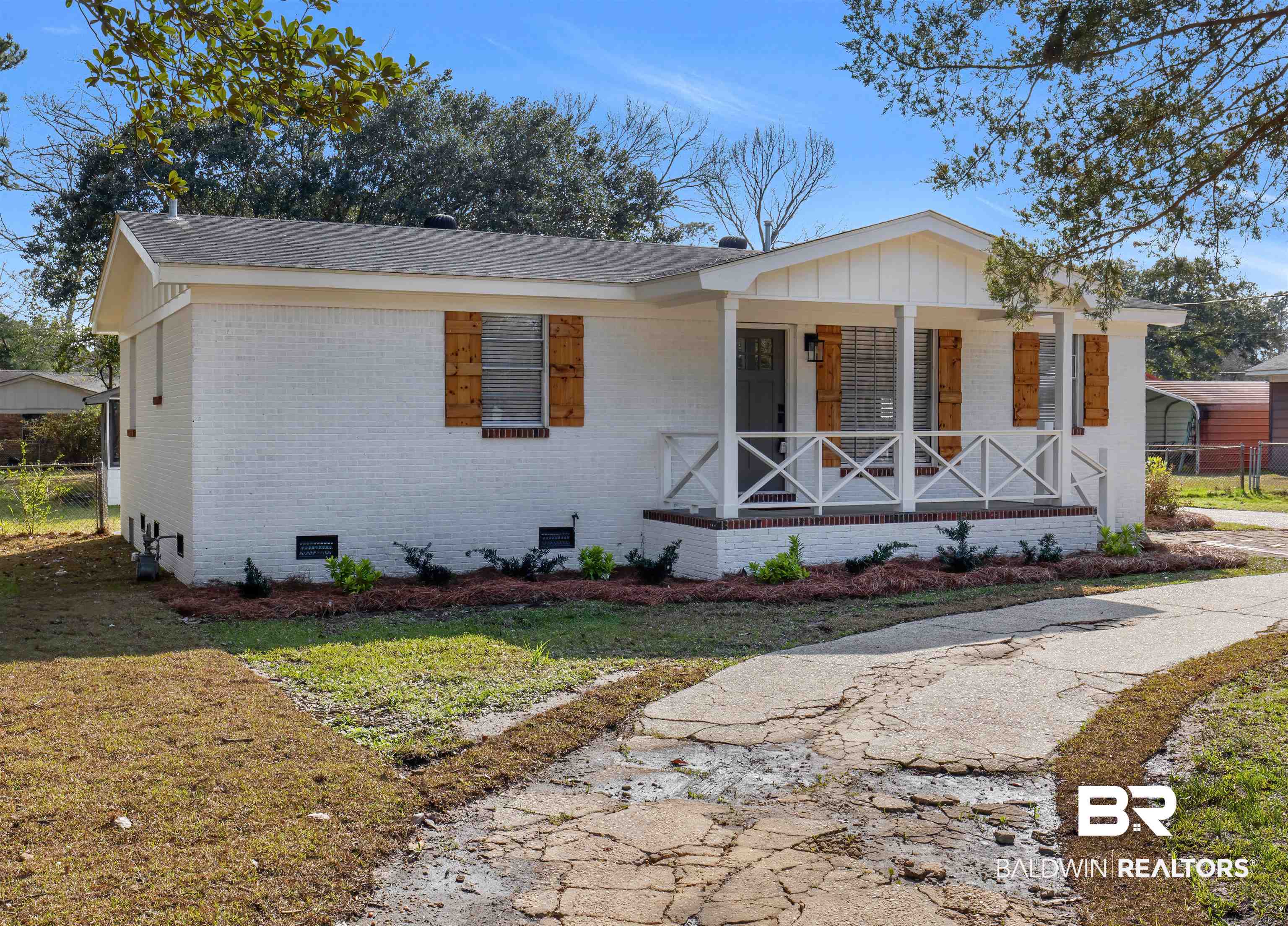 3005 Club House Road Mobile, AL 36605 - Photo 2 of 20 View of front of house with covered porch and a front lawn