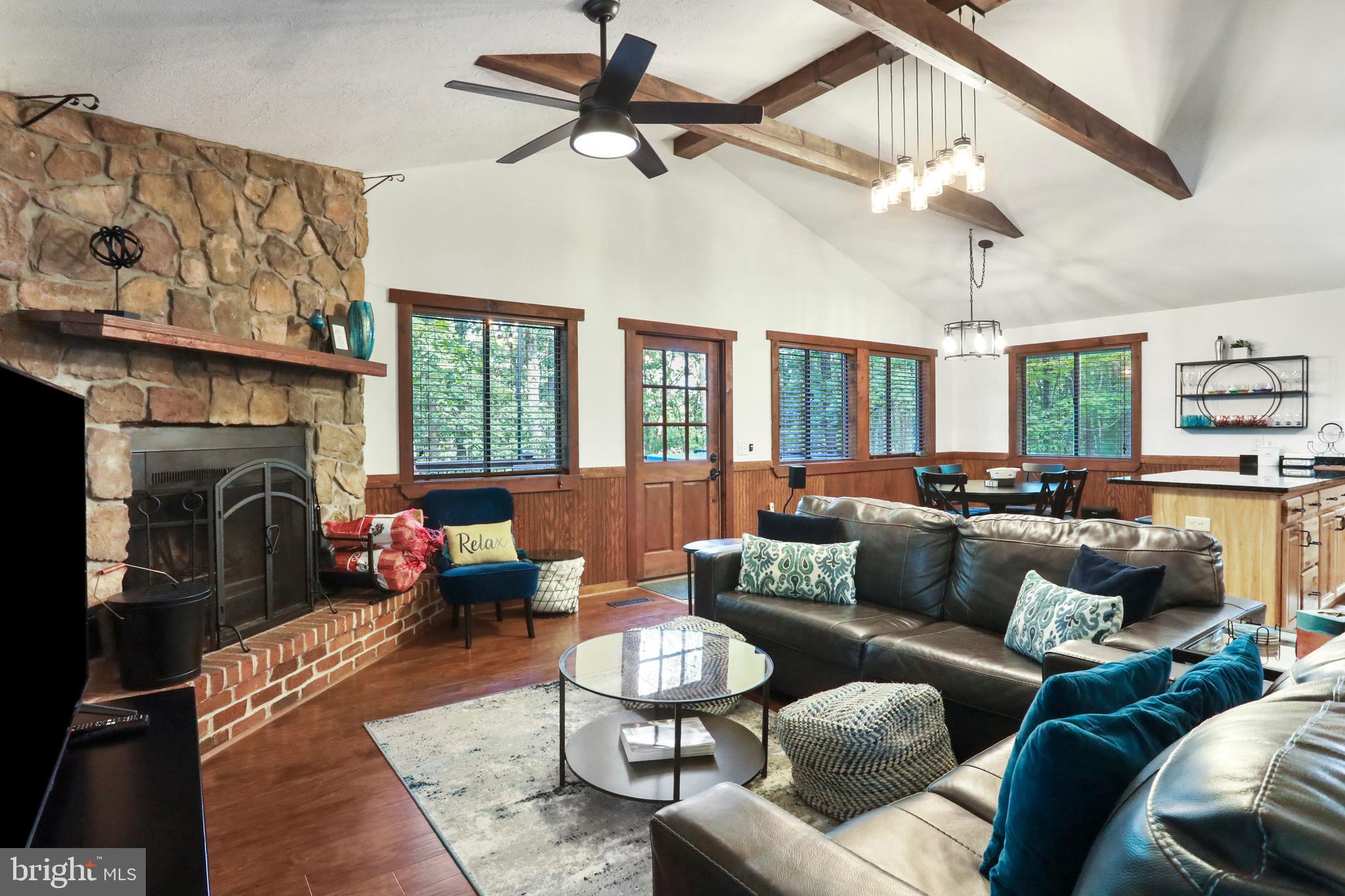 8249 Supinlick Ridge Road Mount Jackson, VA 22842 - Photo 20 of 40 a living room with furniture ceiling fan and a fireplace