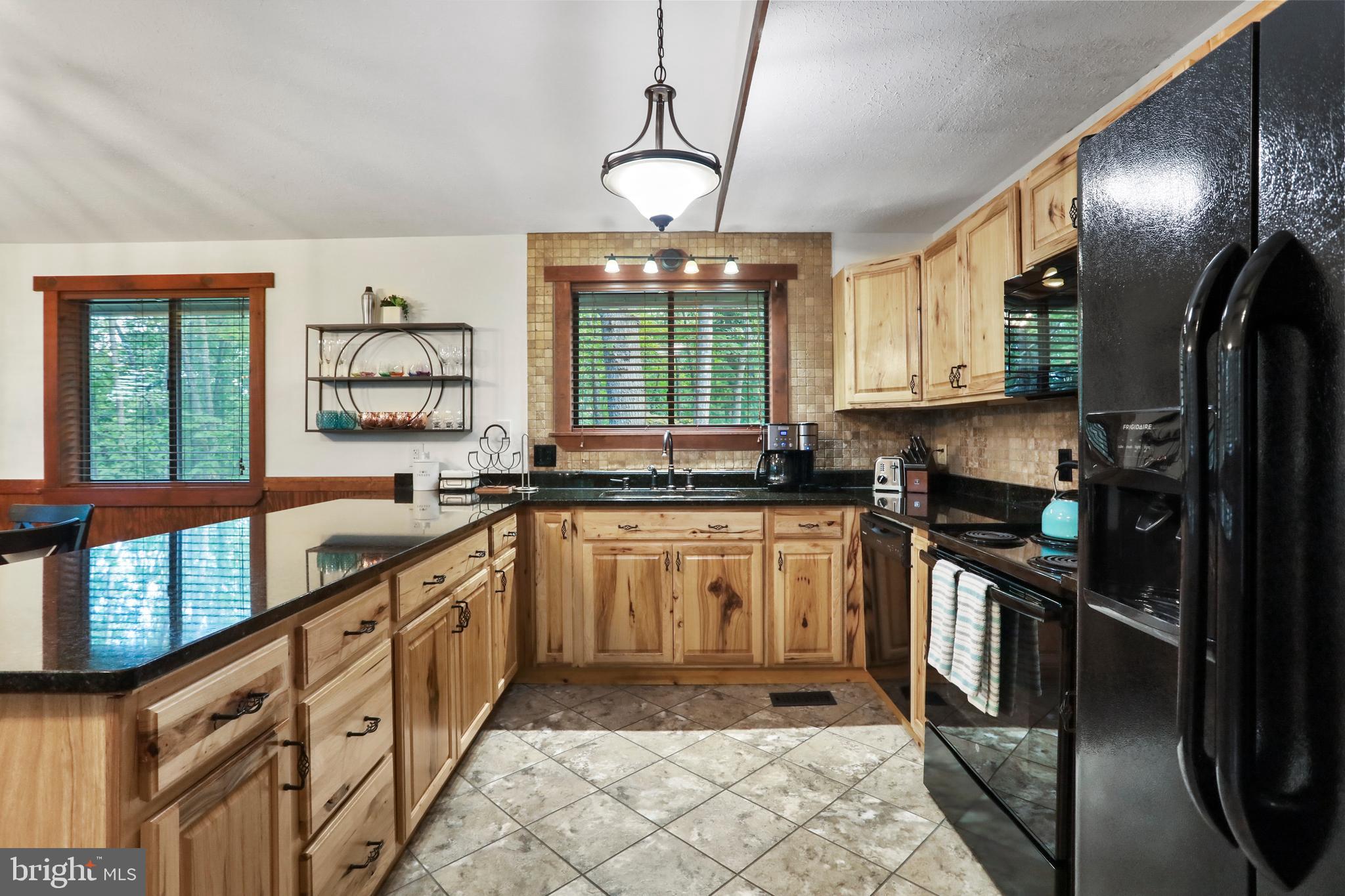 8249 Supinlick Ridge Road Mount Jackson, VA 22842 - Photo 23 of 40 a kitchen with granite countertop a stove sink and refrigerator