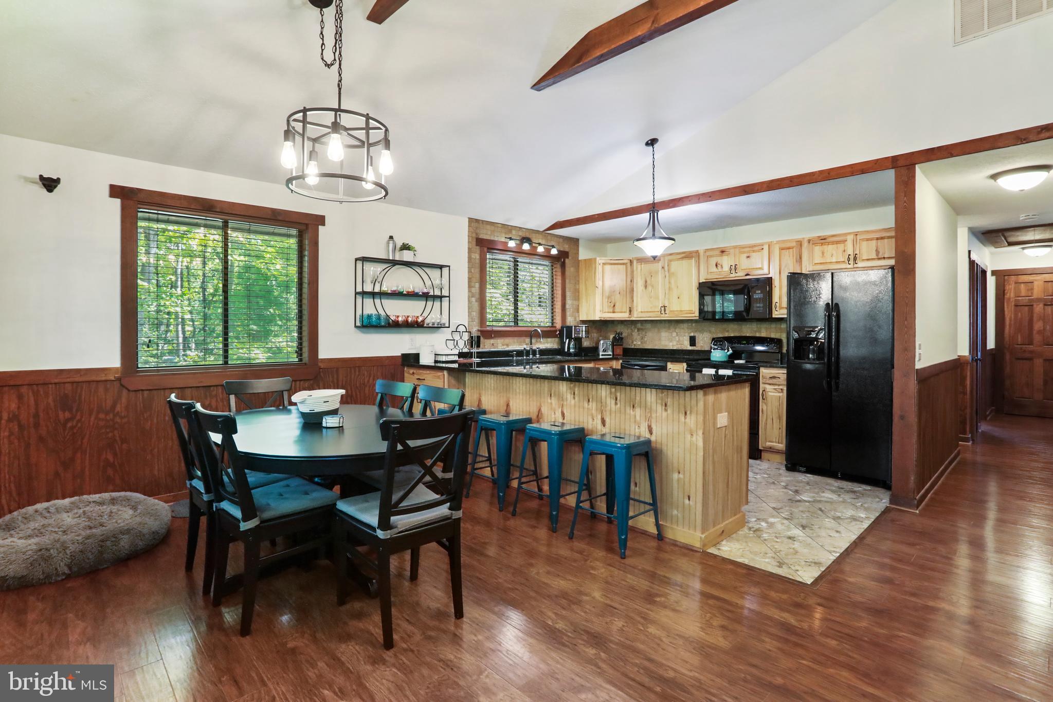 8249 Supinlick Ridge Road Mount Jackson, VA 22842 - Photo 26 of 40 a dining room with furniture a chandelier and wooden floor