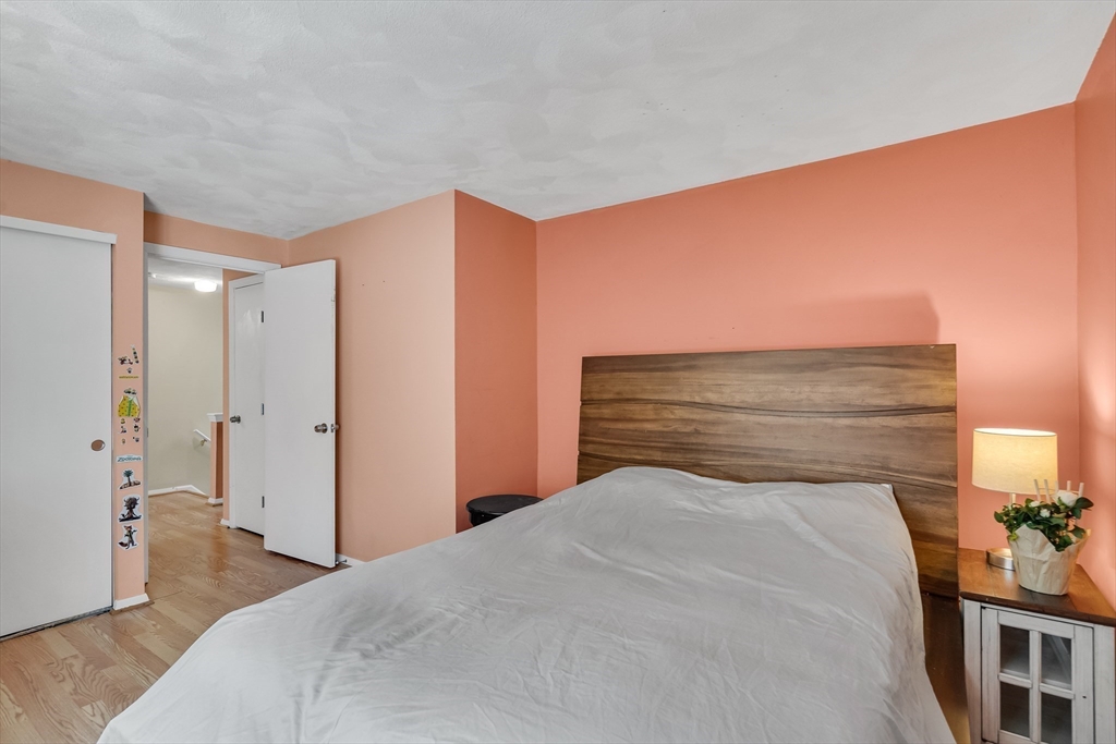 58 MacIntosh Lane, Unit 58 Boxborough, MA 01719 - Photo 17 of 23 a bedroom with a bed and a couch