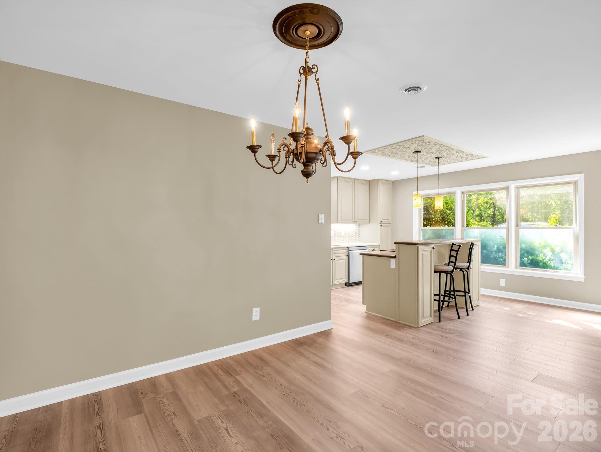44 Jervey Road, Unit 4C Tryon, NC 28782 - Photo 6 of 35 a view of a dining room with furniture wooden floor and chandelier