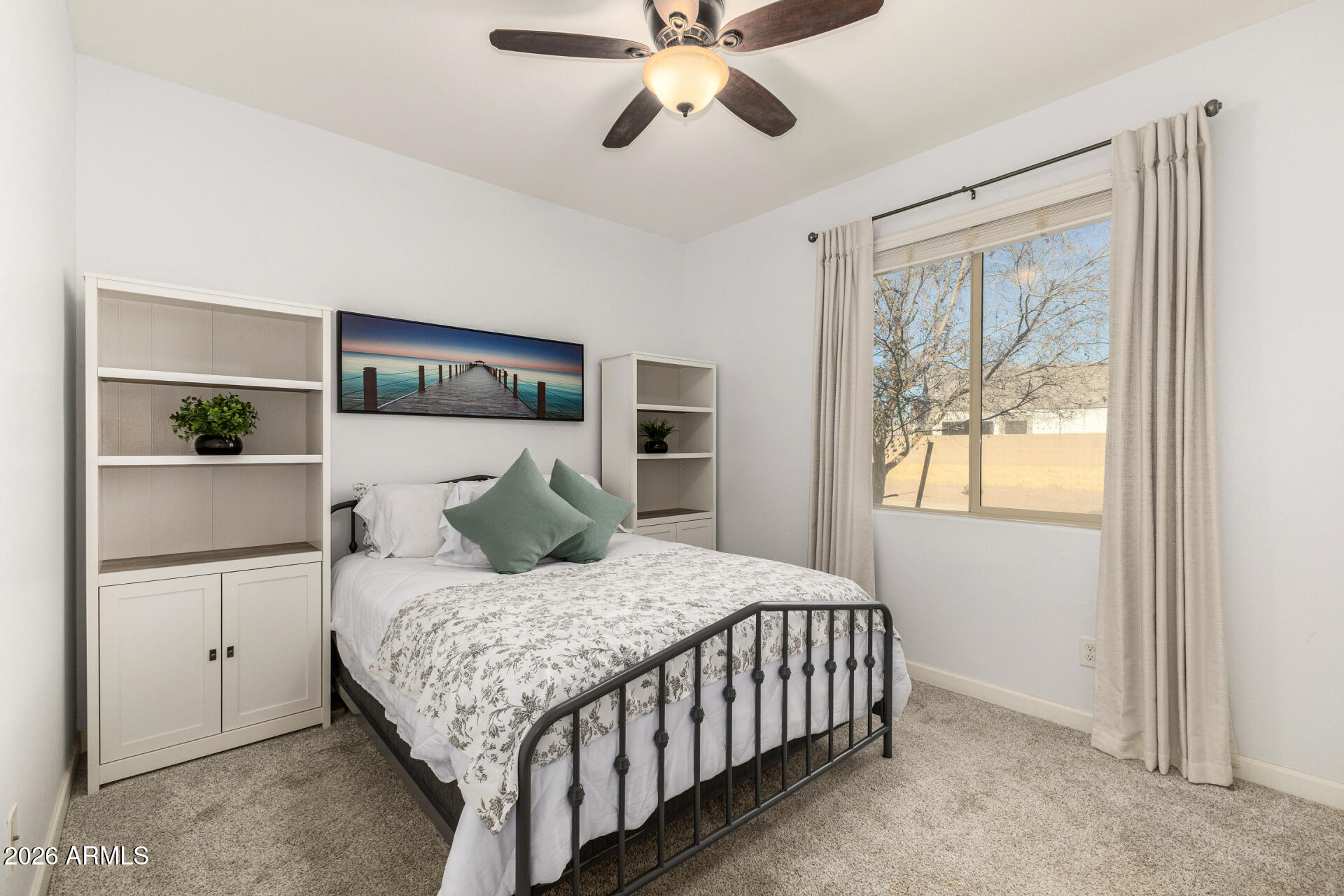 41039 West Williams Way Maricopa, AZ 85138 - Photo 14 of 25 a bedroom with a large bed and a chandelier fan