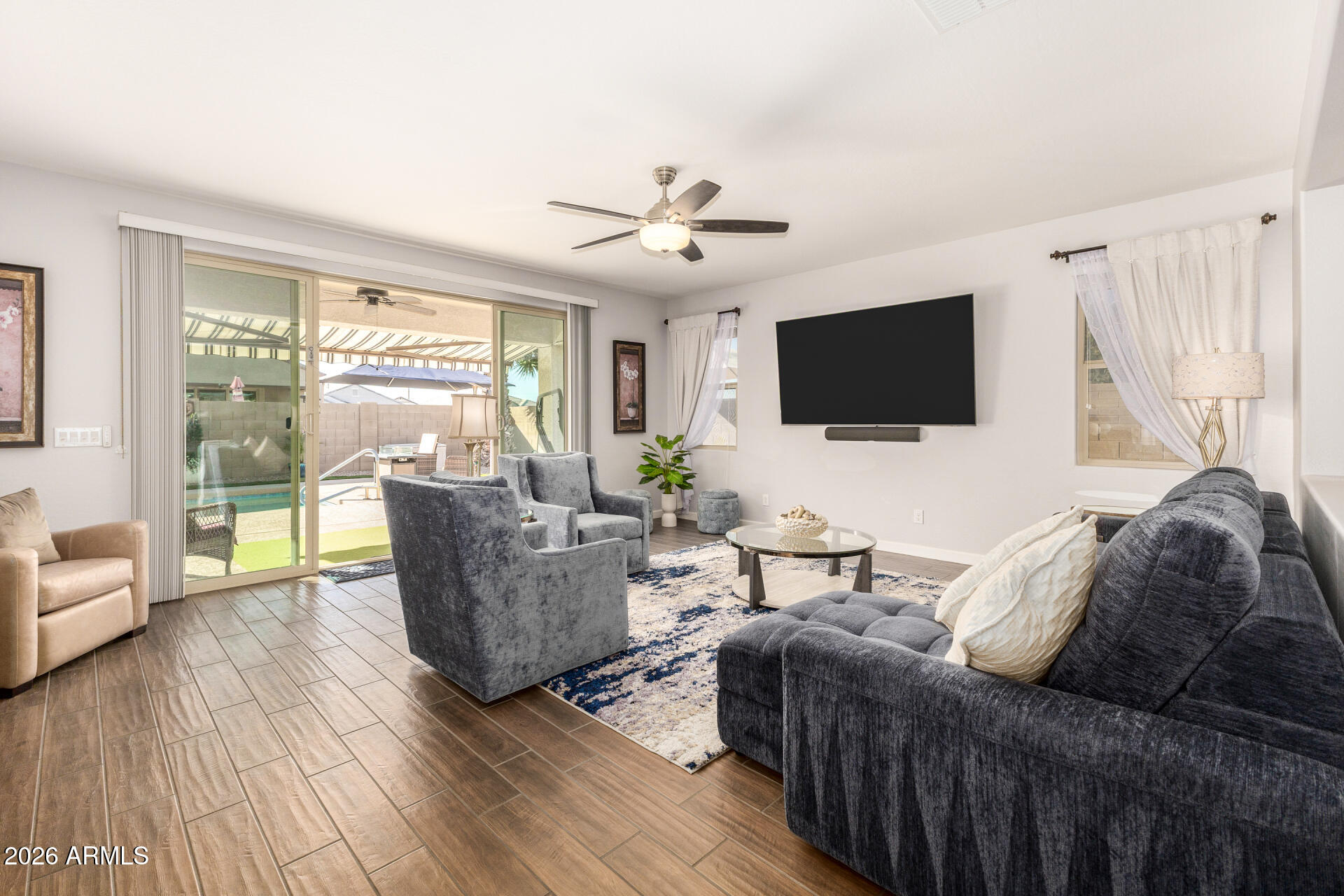 41039 West Williams Way Maricopa, AZ 85138 - Photo 2 of 25 a living room with furniture and a flat screen tv