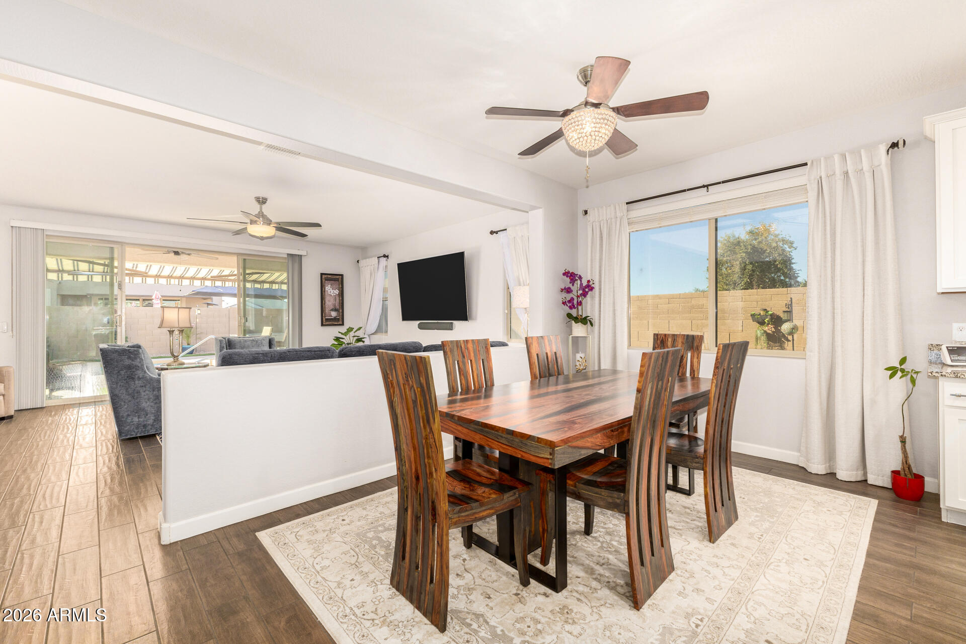 41039 West Williams Way Maricopa, AZ 85138 - Photo 5 of 25 a view of a dining room with furniture window and wooden floor