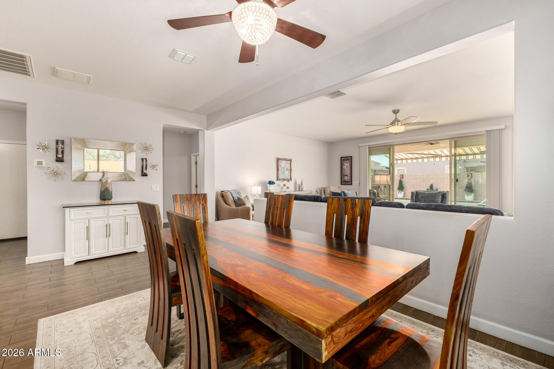 41039 West Williams Way Maricopa, AZ 85138 - Photo 6 of 25 a dining room with furniture a window and wooden floor