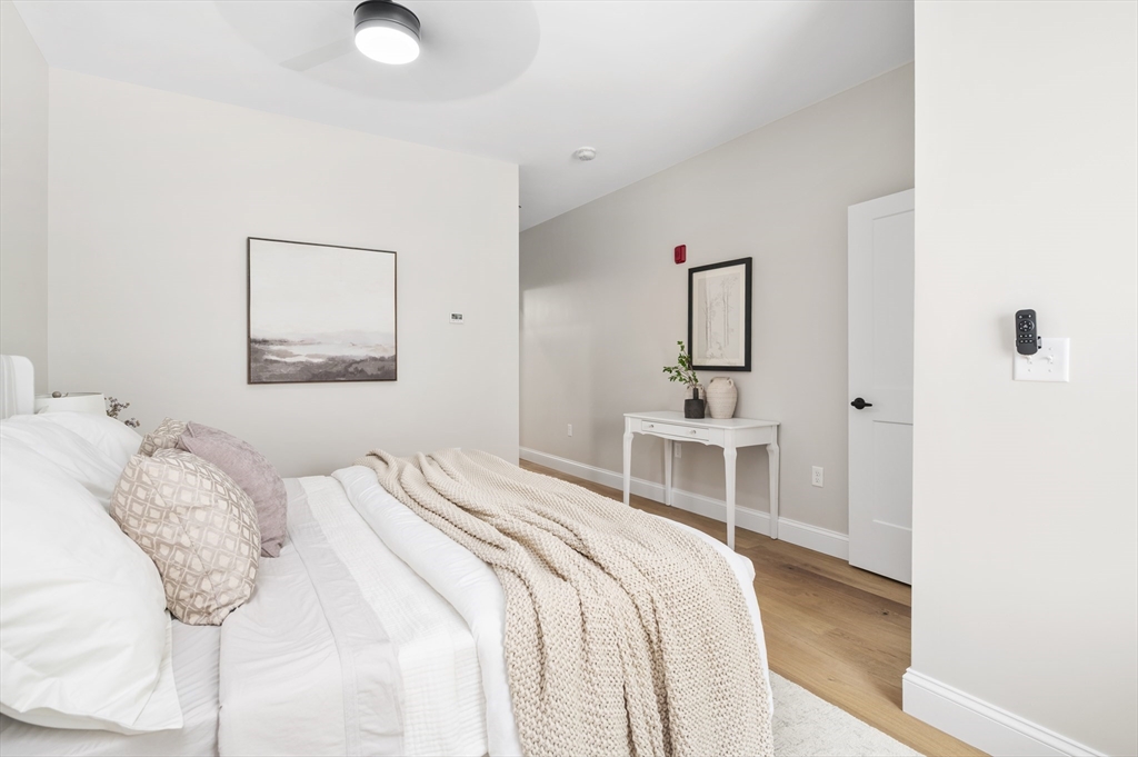 36 Old Louisquisset Pike, Unit 106 North Smithfield, RI 02896 - Photo 12 of 30 a bedroom with a bed and a chair