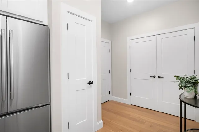a view of a hallway with wooden floor