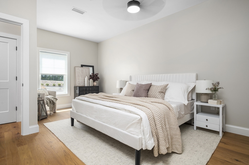 36 Old Louisquisset Pike, Unit 106 North Smithfield, RI 02896 - Photo 16 of 30 a spacious bedroom with a bed and a couch