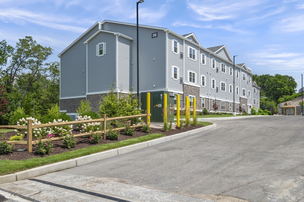 36 Old Louisquisset Pike, Unit 106 North Smithfield, RI 02896 - Photo 2 of 30 a front view of a building with street view