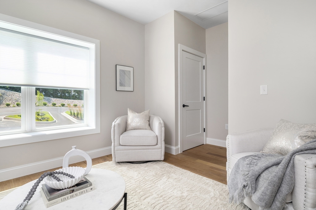 36 Old Louisquisset Pike, Unit 106 North Smithfield, RI 02896 - Photo 21 of 30 a bedroom with furniture and a window