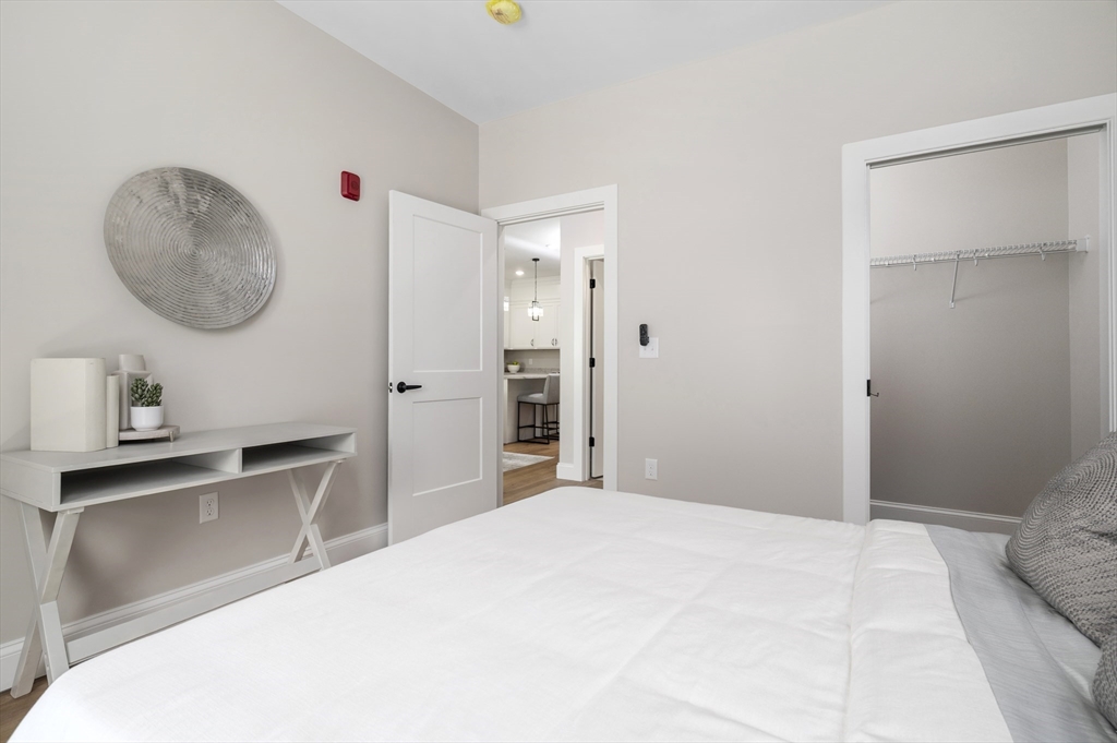 36 Old Louisquisset Pike, Unit 106 North Smithfield, RI 02896 - Photo 24 of 30 a bedroom with a bed and a chandelier