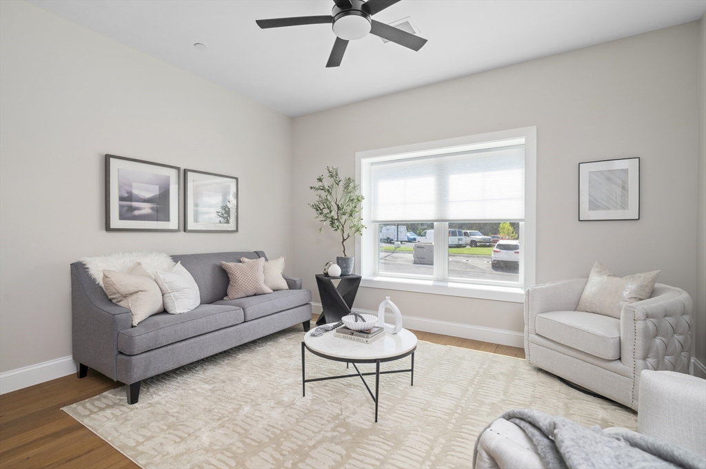 36 Old Louisquisset Pike, Unit 106 North Smithfield, RI 02896 - Photo 7 of 30 a living room with furniture and a large window