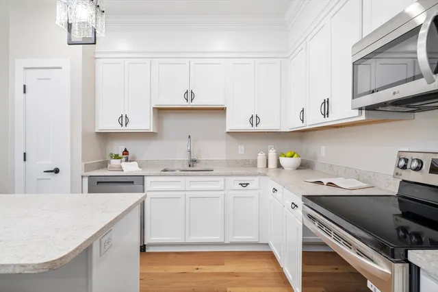 a kitchen with a sink stove and cabinets
