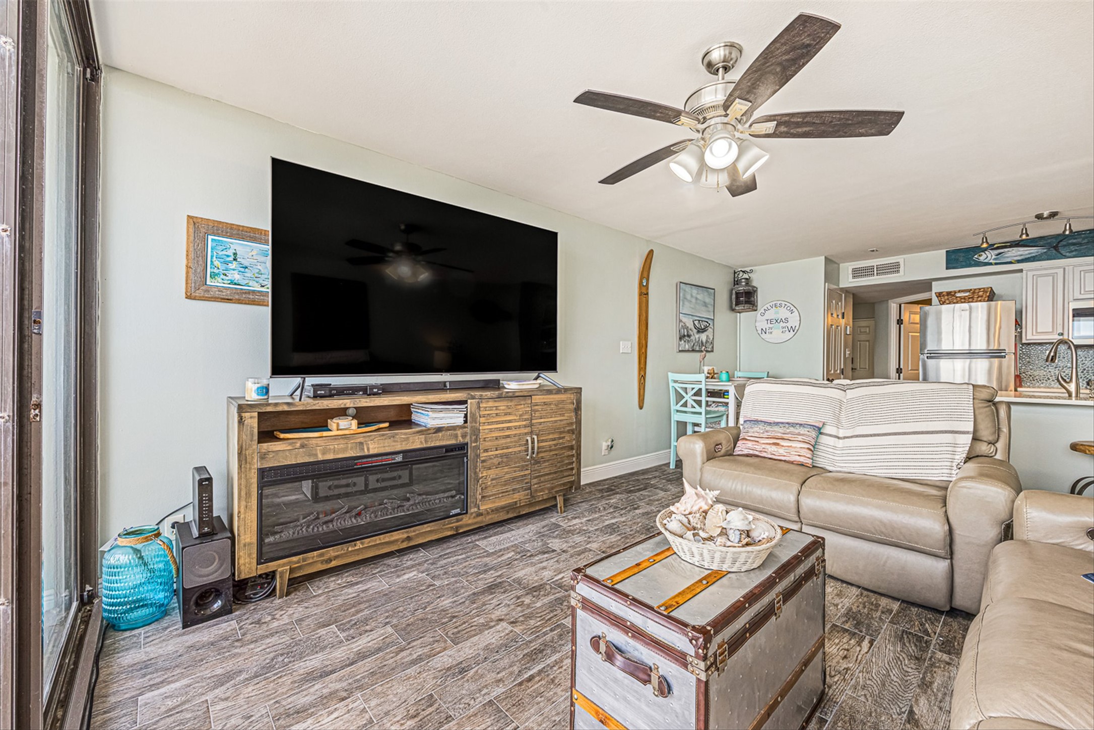11945 Termini-San Luis Pass Road, Unit 406 Galveston, TX 77554 - Photo 11 of 26 Living area with ceiling fan and wood finished floors