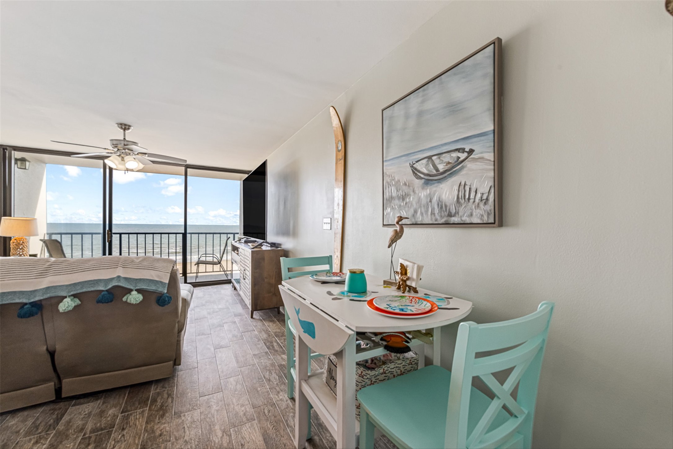 11945 Termini-San Luis Pass Road, Unit 406 Galveston, TX 77554 - Photo 18 of 26 Dining space with floor to ceiling windows, wood finished floors, and ceiling fan