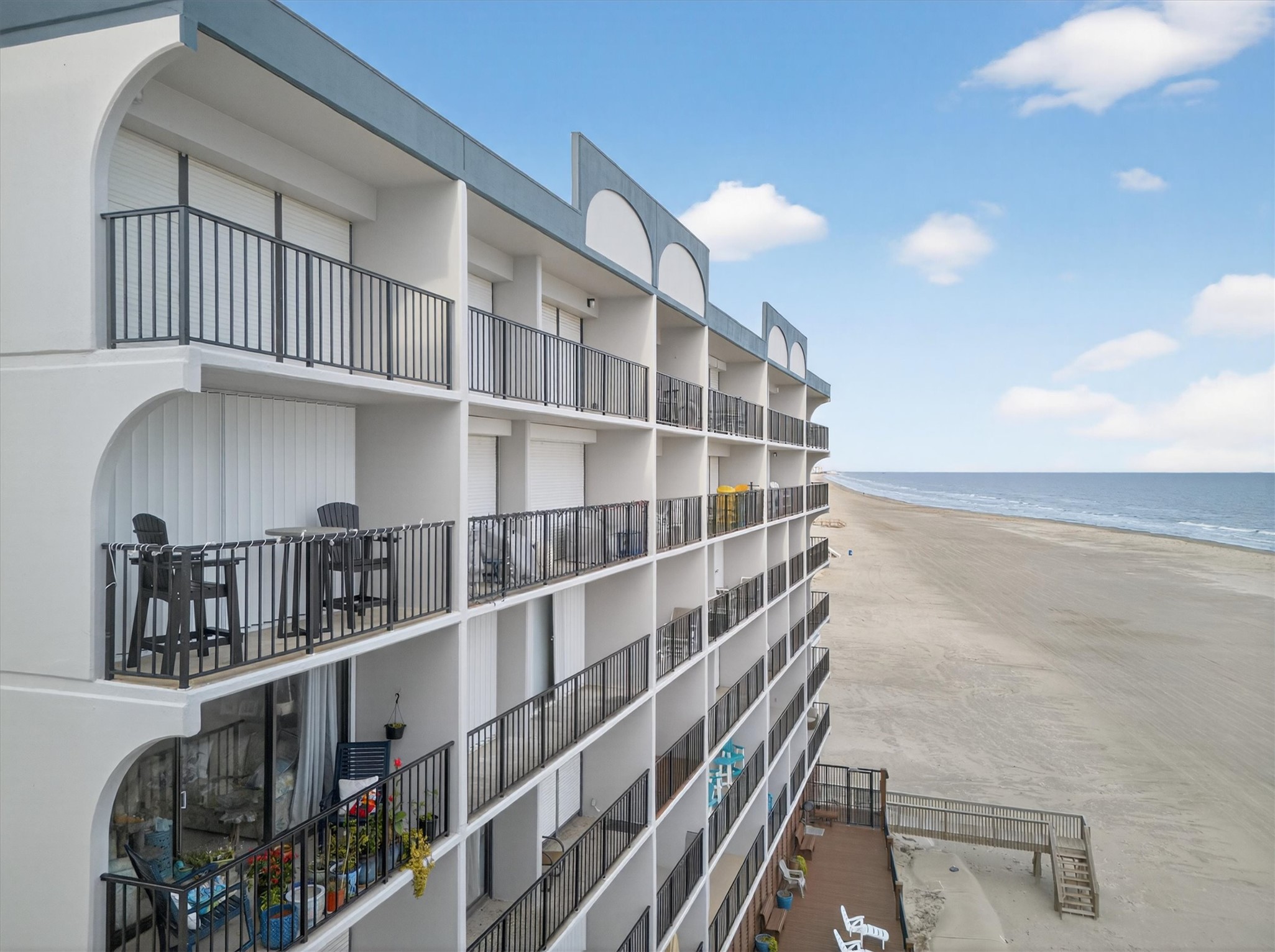 11945 Termini-San Luis Pass Road, Unit 406 Galveston, TX 77554 - Photo 2 of 26 View of apartment building / complex with view of water and beach