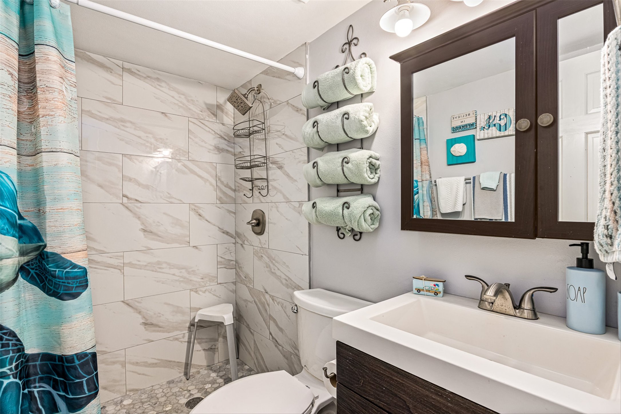 11945 Termini-San Luis Pass Road, Unit 406 Galveston, TX 77554 - Photo 22 of 26 Full bathroom with a shower stall and vanity