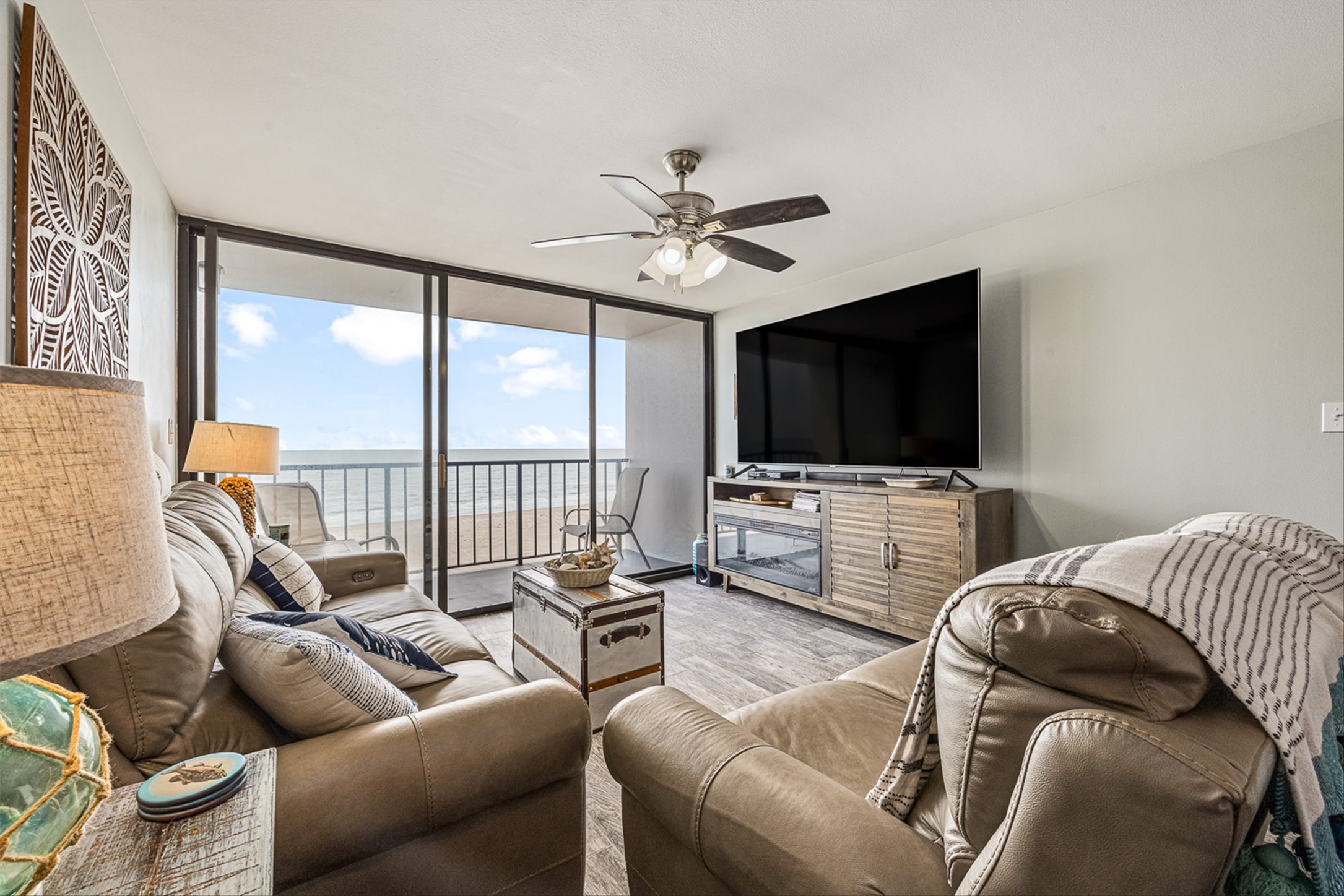 11945 Termini-San Luis Pass Road, Unit 406 Galveston, TX 77554 - Photo 10 of 26 Living area featuring wood finished floors, expansive windows, and a ceiling fan