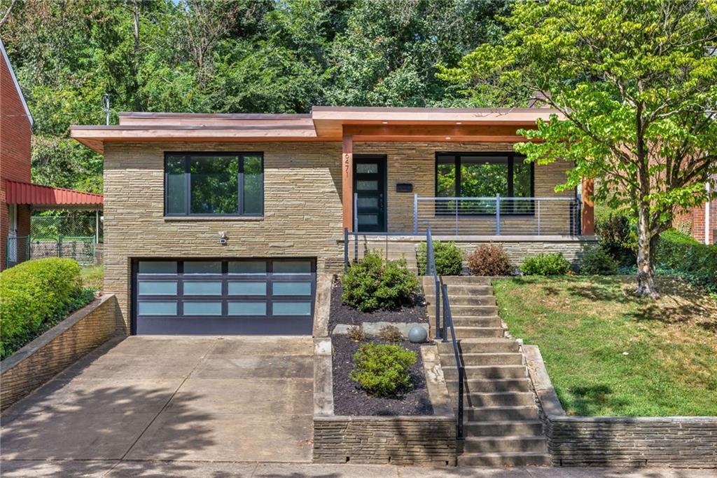 a front view of a house with a garden