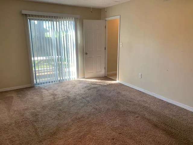 a view of empty room with floor to ceiling window