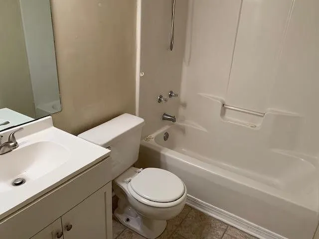 a bathroom with a sink a toilet and bathtub