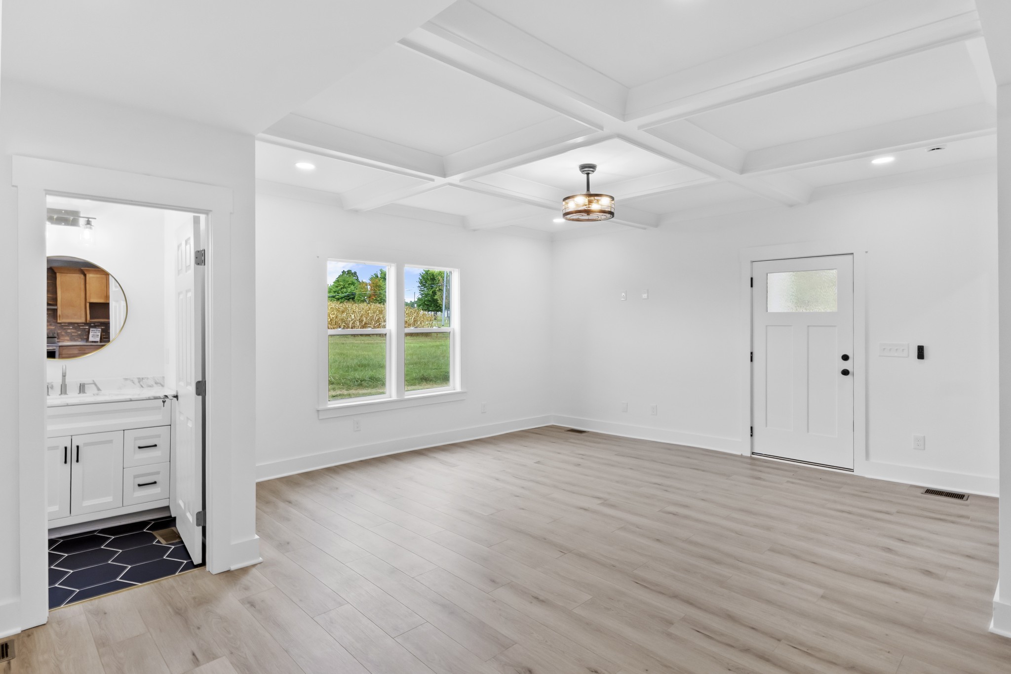 5178 East Robertson Road Cross Plains, TN 37049 - Photo 8 of 44 a view of an empty room with a window and wooden floor
