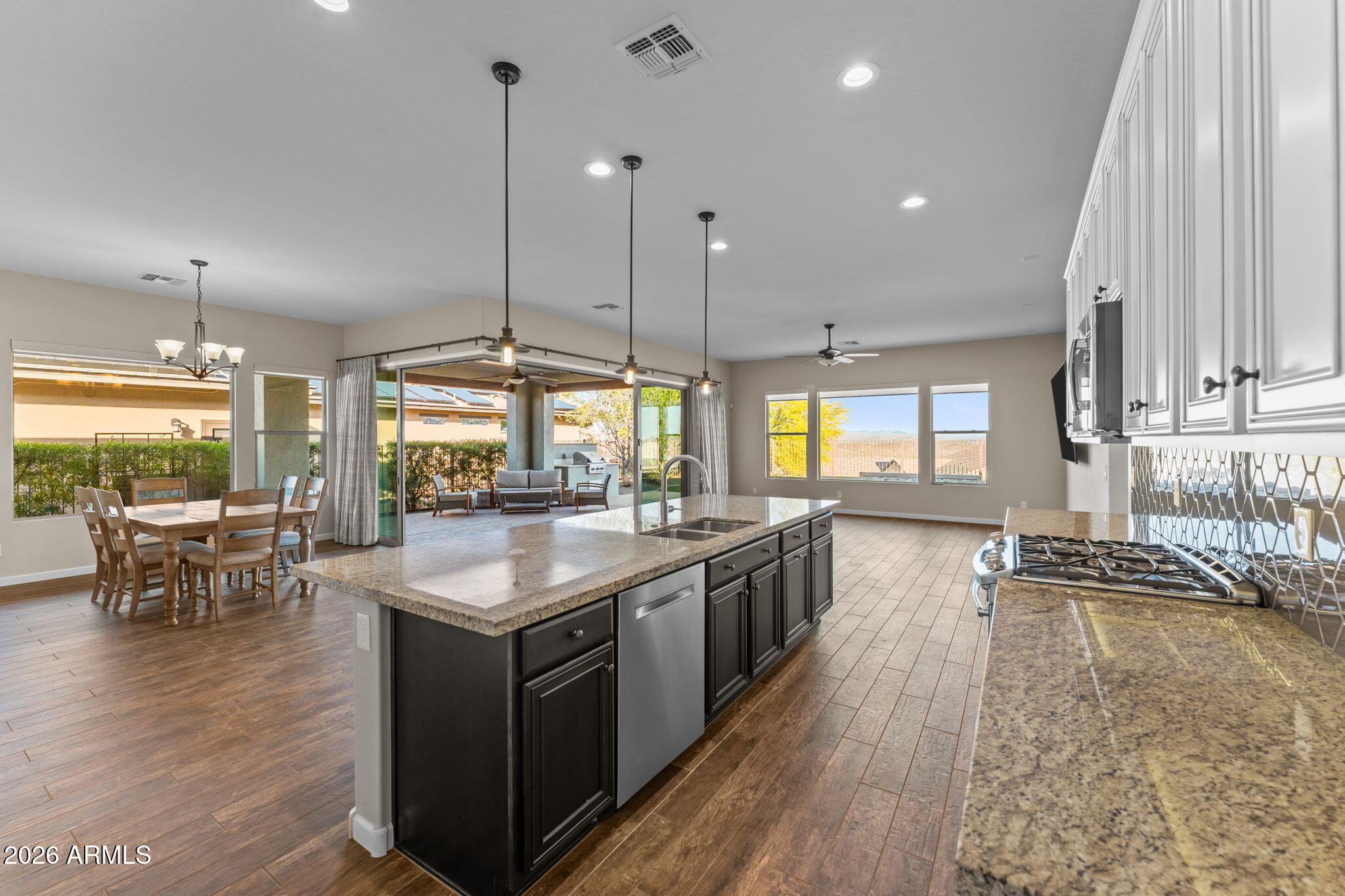 3675 Gold Ridge Road Wickenburg, AZ 85390 - Photo 13 of 58 a large kitchen with kitchen island a large island in it