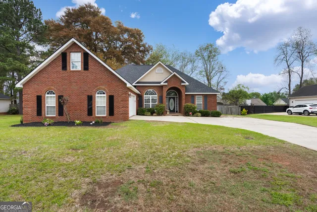 a front view of house with yard and green space