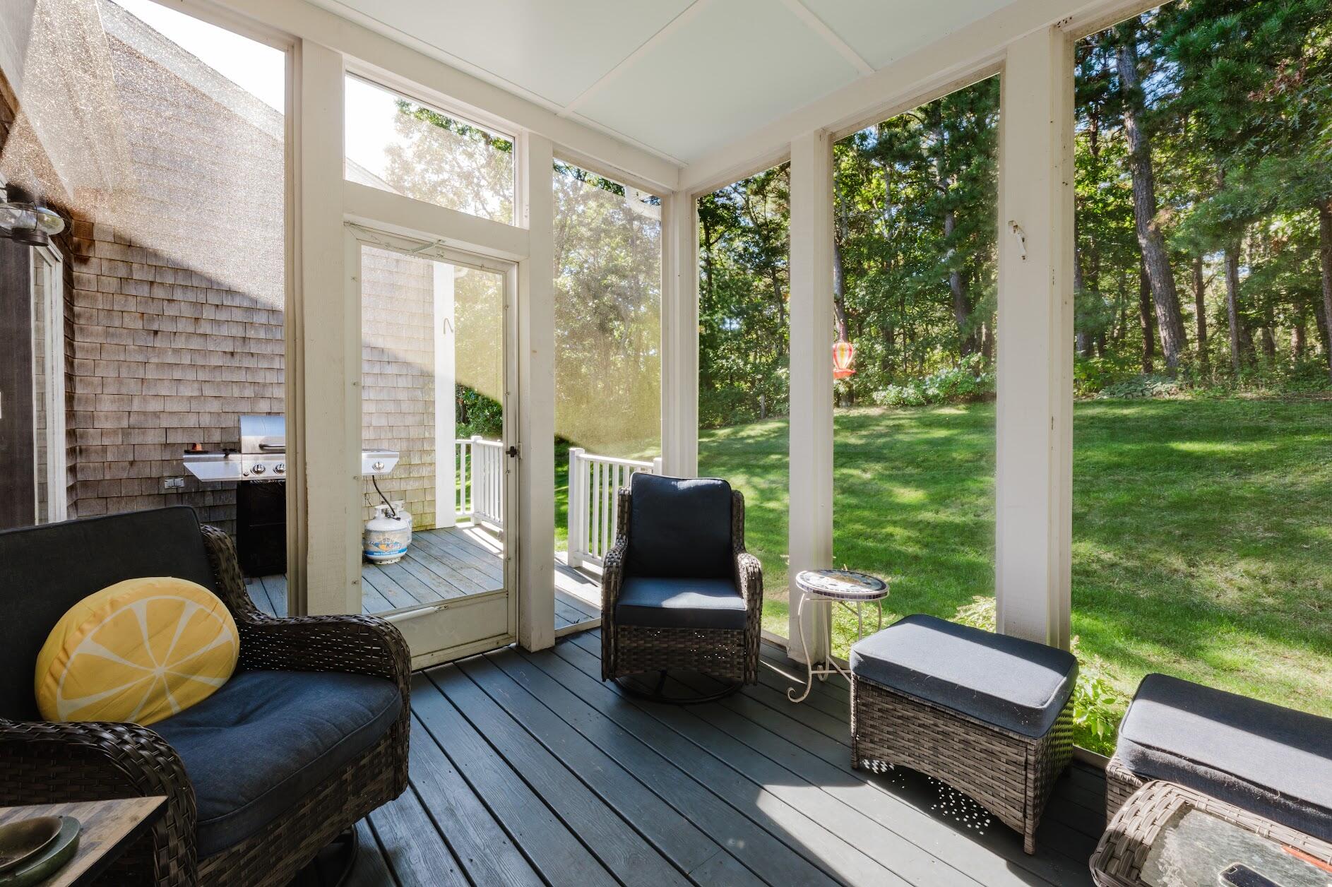 22 Stratford Ridge, Unit 22 Mashpee, MA 02649 - Photo 22 of 40 a living room with furniture and a floor to ceiling window