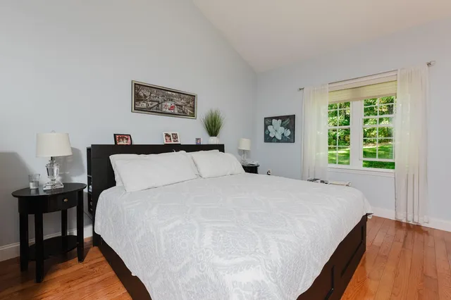 a bedroom with a bed and a night stand