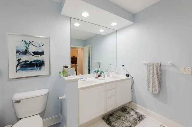a view of bathroom with a toilet sink and mirror