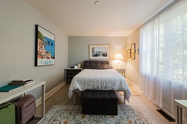 a bed room with a bed and a lamp