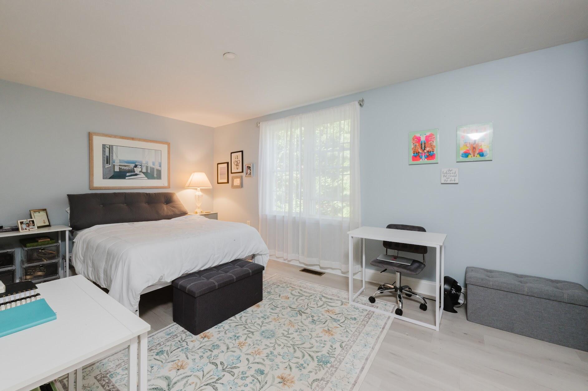 22 Stratford Ridge, Unit 22 Mashpee, MA 02649 - Photo 28 of 40 a bedroom with a bed and a chair