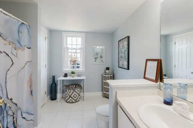 a bathroom with double vanity and tub