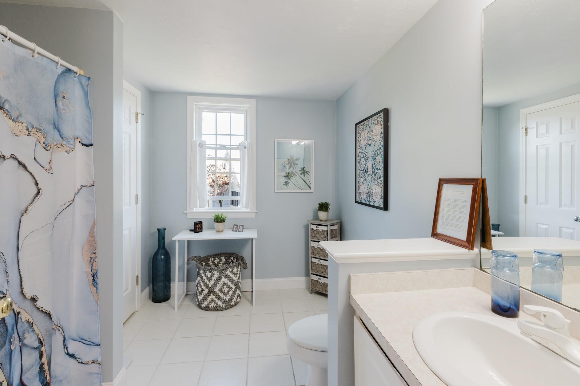 22 Stratford Ridge, Unit 22 Mashpee, MA 02649 - Photo 29 of 40 a bathroom with double vanity and tub