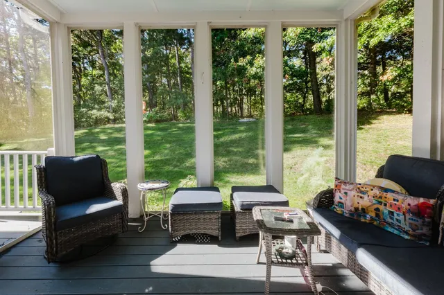 a bedroom with a bed and large windows
