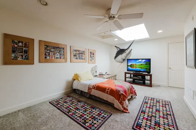 a bedroom with furniture and a rug