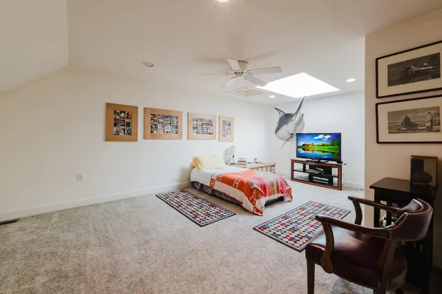 a living room with furniture and a baby crib