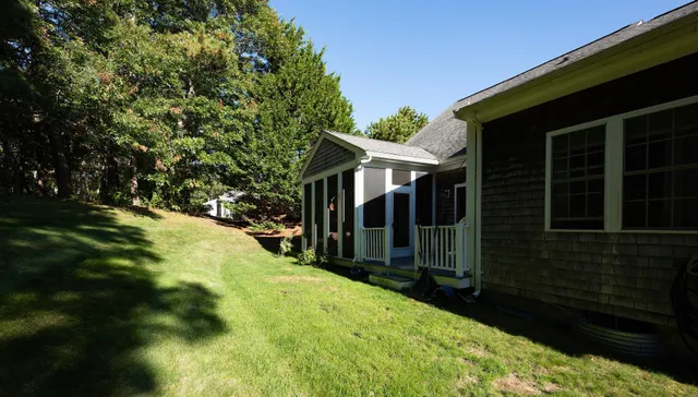 a view of a house with backyard and porch