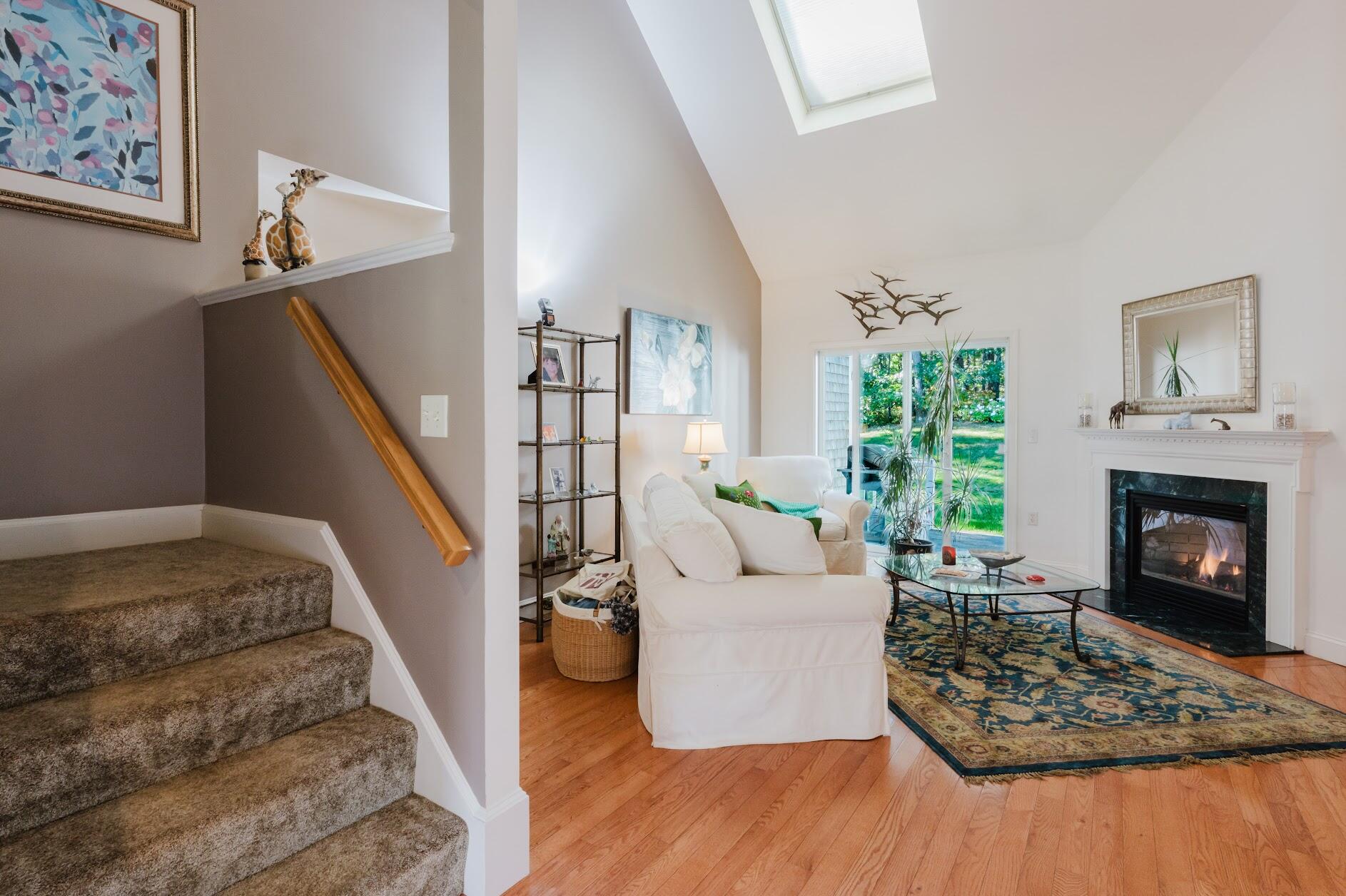 22 Stratford Ridge, Unit 22 Mashpee, MA 02649 - Photo 5 of 40 a living room with furniture and a fireplace