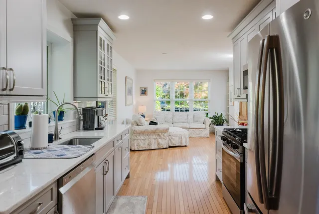 a kitchen with sink refrigerator and window