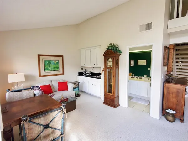 a living room with furniture gym equipment and a chandelier