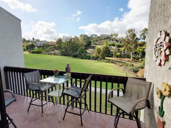 a view of a chairs and table in patio