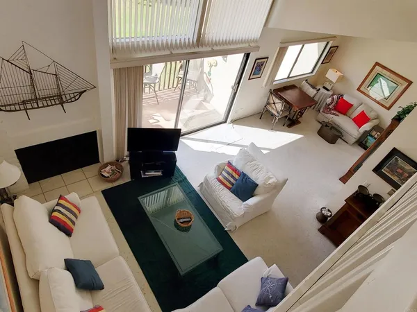 a living room with a couch and a floor to ceiling window