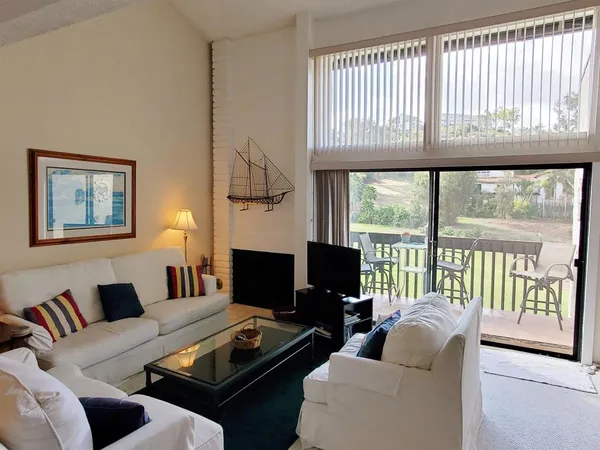 a living room with furniture tv and a large window