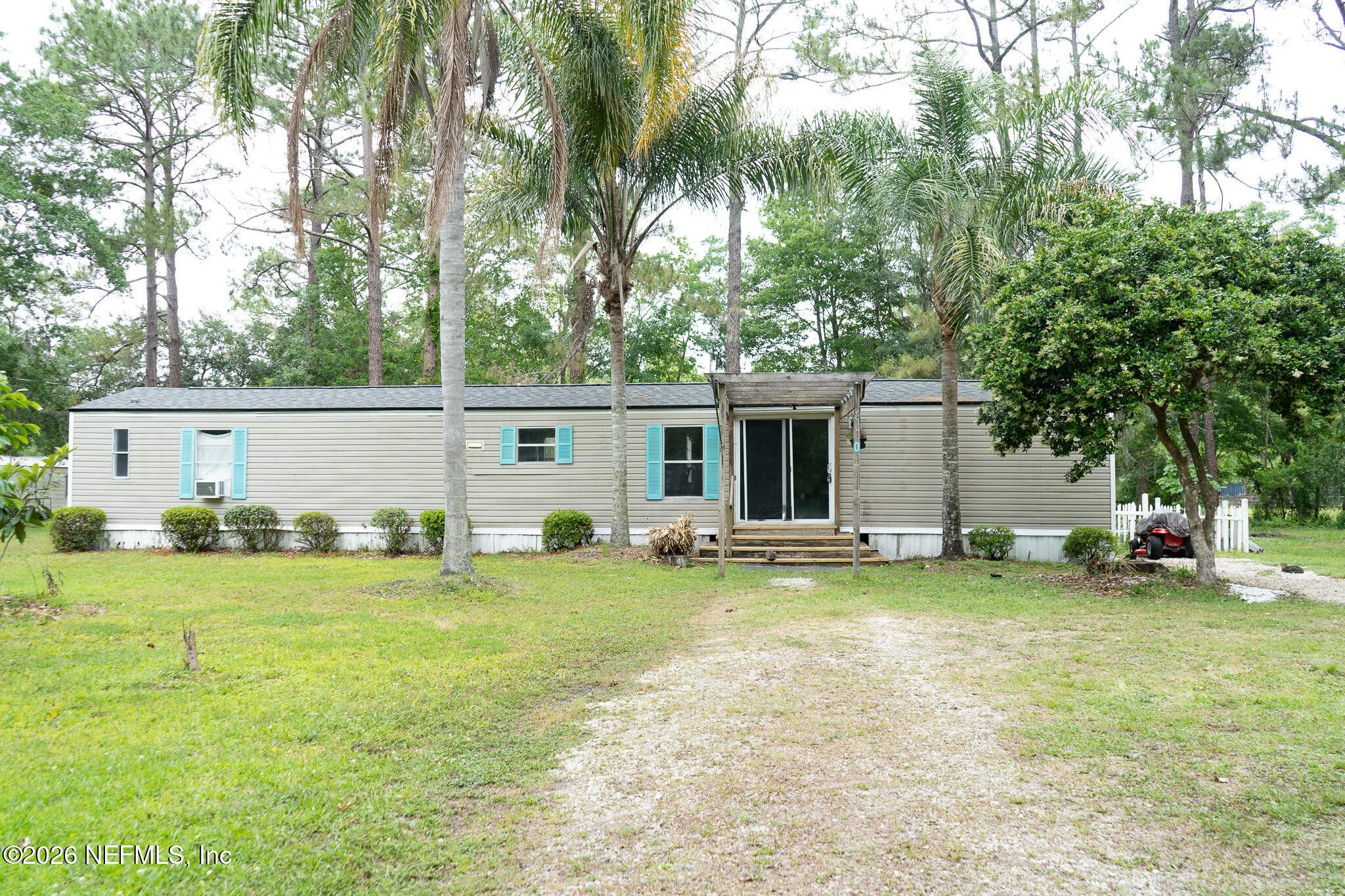 3180 Pacetti Road, Unit A St. Augustine, FL 32092 - Photo 1 of 23 a view of a house with backyard and a tree