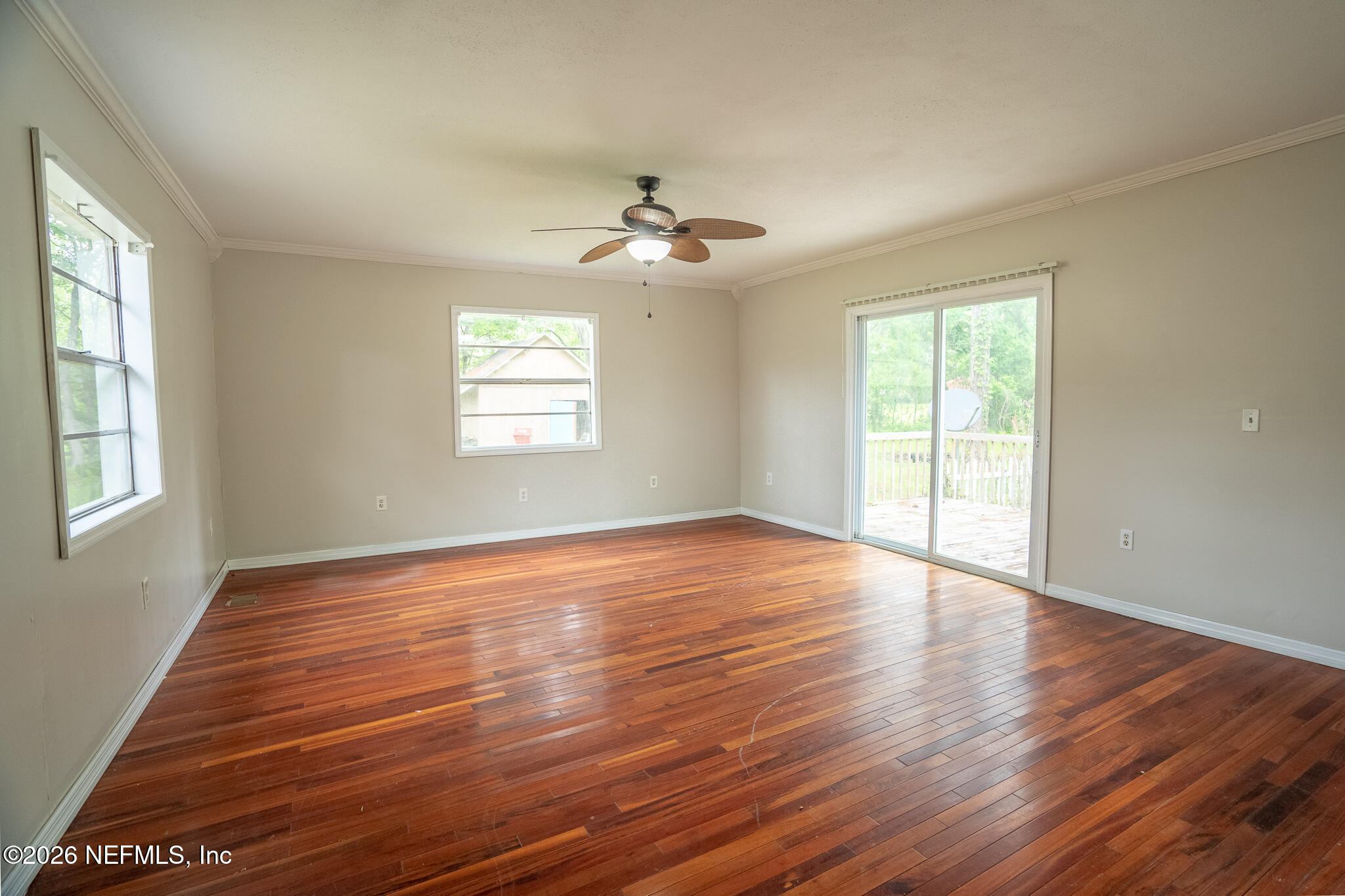 3180 Pacetti Road, Unit A St. Augustine, FL 32092 - Photo 17 of 23 a view of an empty room with wooden floor and a window