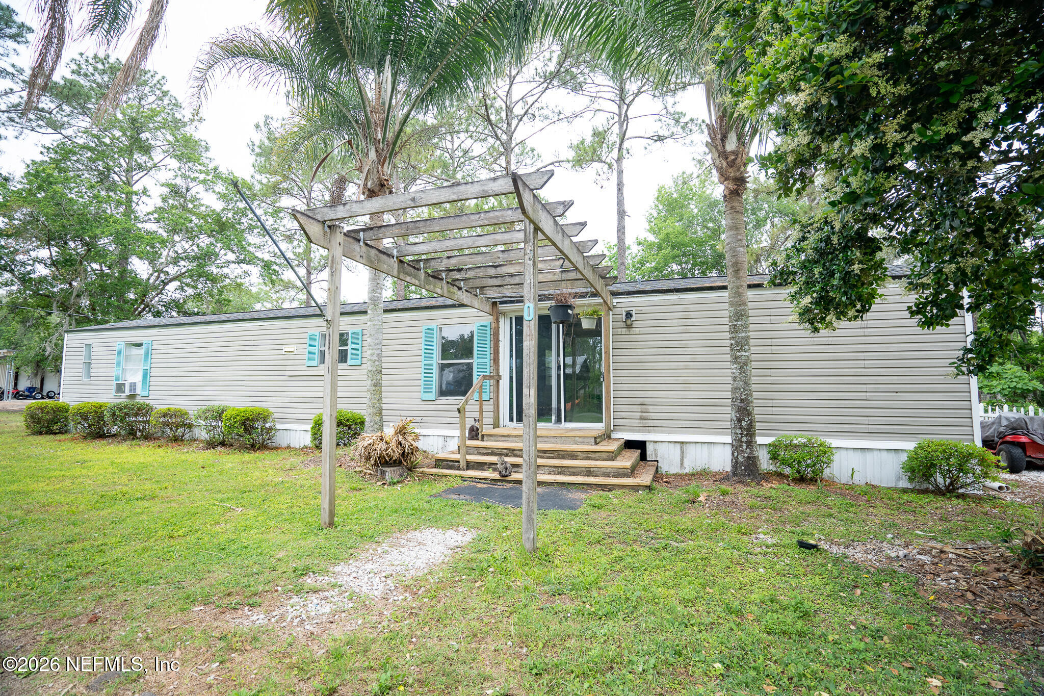 3180 Pacetti Road, Unit A St. Augustine, FL 32092 - Photo 3 of 23 a backyard of a house with table and chairs